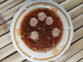 A Plate of Indonesian Meatball Soup or Bakso on Bamboo Surface