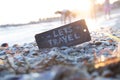 Lets travel tag. A plate with the inscription on a beautiful beach