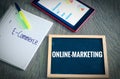 Plate with the inscription Online-Marketing andE-Commerce with a tablet Graphs and statistics and block to illustrate the increase Royalty Free Stock Photo