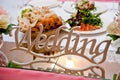 The plate with the inscription wedding set on the served table of the newlyweds Royalty Free Stock Photo