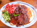 Iskender doner kebap with yoghurt and salad.