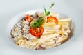 Plate of Italian penne pasta topped with a creamy sauce. Royalty Free Stock Photo