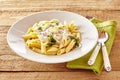 Plate of Italian penne pasta topped with a sauce Royalty Free Stock Photo