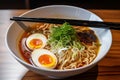 a plate of japanese ramen, with thick noodles in a flavorful broth
