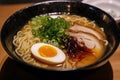 a plate of japanese ramen, with thick noodles in a flavorful broth