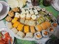 Plate with japanese sushi rolls on the table. Cloth with the Ukrainian ornament `vyshivanka`.