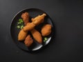 Food Juicy Fried Chicken on a Black Plate with Parsley