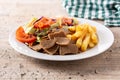 Plate of kebab, vegetables and french fries