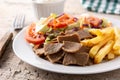 Plate of kebab, vegetables and french fries
