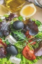 Plate with keto diet food. Chopped vegetables for the ketogenic diet on a plate. Tomatoes, salad with arugula, avocado and olives Royalty Free Stock Photo