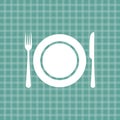 Plate knife and fork on turquoise tablecloth