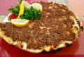Plate of Lahmacun, a Crispy Turkish Pizza Topped with Spiced Minced Meat Royalty Free Stock Photo