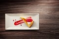 Plate of lemon tart with raspberry coulis