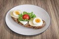 Egg And Cheese Sandwich With Lettuce And Cherry Tomato Served On Porcelain Plate Set On Walnut Wood Surface Royalty Free Stock Photo