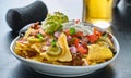 Plate of loaded nachos with queso cheese Royalty Free Stock Photo