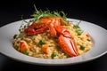 Plate of Lobster Risotto with green peas on black background