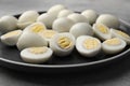 Plate with many peeled hard boiled quail eggs on grey table Royalty Free Stock Photo