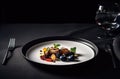 Plate with meal on it served on a black table with a fork, knife and glass. Created with Generative AI Royalty Free Stock Photo