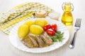 Plate with meat aspic, boiled potatoes, tomatoes, dill, horseradish, mustard