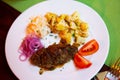 Plate with a meat dish lula-kebab and stewed potatoes.