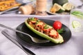 Plate with meat stuffed zucchini boat on table Royalty Free Stock Photo