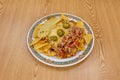 Plate of Mexican corn nachos with lots of cheese, lots of guacamole and lots of pico de gallo on white plate Royalty Free Stock Photo