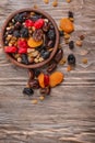 Plate with mix of dried fruits and berries on wooden background Royalty Free Stock Photo