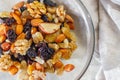 A plate with a mixture of nuts and dried fruits, raisins, walnuts, hazelnuts, almonds, cashews Royalty Free Stock Photo