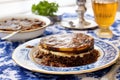 a plate of moussaka dish on a blue-and-white tablecloth