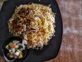 A plate of Mutton Briyani Rice with pickles