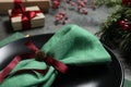 Plate, napkin and Christmas decor on grey table, closeup Royalty Free Stock Photo