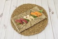 Plate of nigiri on wicker trivet Royalty Free Stock Photo