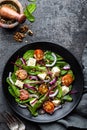 Nutritious simple salad with chard, walnuts, soft cheese, onions and oil