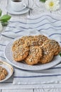 On a plate oatmeal cookies with seeds, white light wooden background