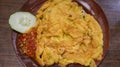 A plate of omelette egg with deep fried cook and traditional sambal or mashed chili sauce. Indonesian style cuisine