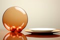 a plate with an orange glass and two ornaments on it Royalty Free Stock Photo