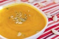 Plate orange pumpkin osupa with seeds, vegetable autumn soup