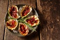 Plate of Oysters Kilpatrick on Rustic Wooden Table