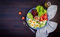 Plate with a paleo diet food. Boiled eggs, avocado, cucumber, nuts, cherry and strawberries. Royalty Free Stock Photo