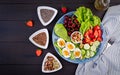 Plate with a paleo diet food. Boiled eggs, avocado, cucumber, nuts, cherry and strawberries. Royalty Free Stock Photo