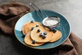 Plate with pancakes, berries and sugar powder