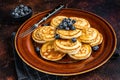 Plate with pancakes with fresh blueberries and syrup . Dark background. Top View Royalty Free Stock Photo