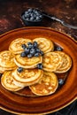 Plate with pancakes with fresh blueberries and syrup . Dark background. Top View Royalty Free Stock Photo