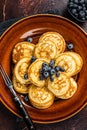 Plate with pancakes with fresh blueberries and syrup . Dark background. Top View Royalty Free Stock Photo