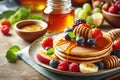 A plate pancakes with fruit on top and jar of honey Royalty Free Stock Photo