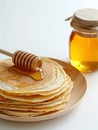 Plate of pancakes and glass jar of honey. Royalty Free Stock Photo