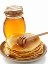 Plate of pancakes and glass jar of honey. Royalty Free Stock Photo