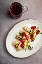 Plate of pancakes topped with strawberries, with a filling, served with a glass of tea Royalty Free Stock Photo