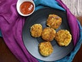 A plate with Paneer Cutlet, a breaded crispy patty.