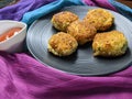 A plate with Paneer Cutlet, a breaded crispy patty